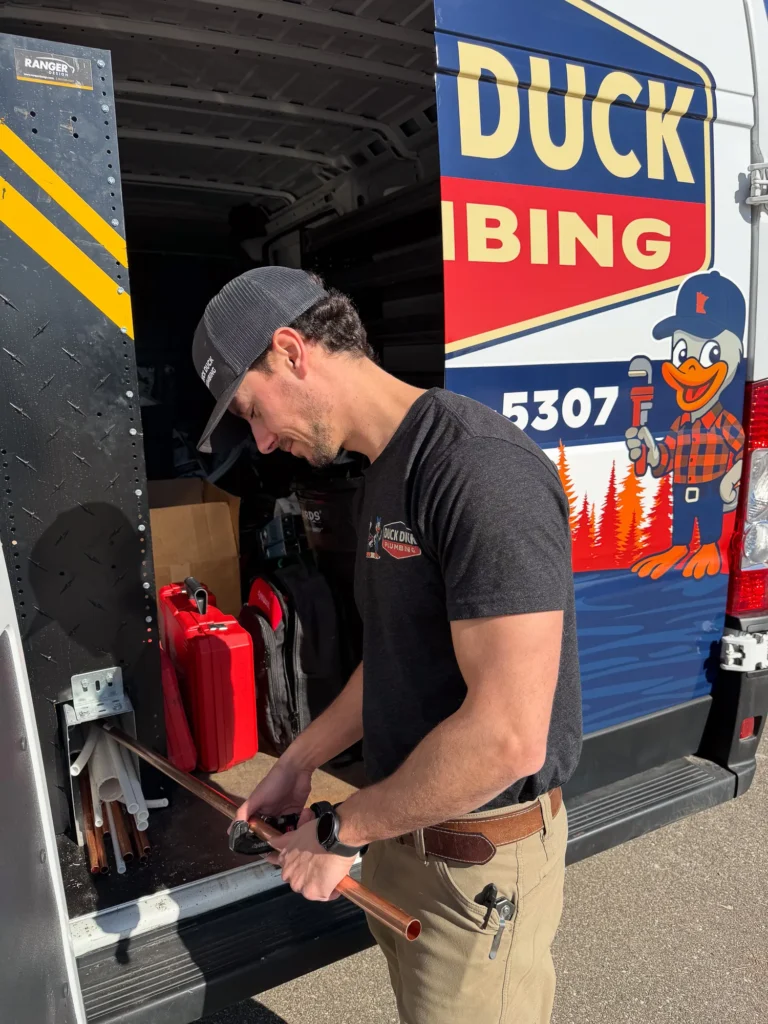 Cutting copper at the van by Duck Duck Plumbing